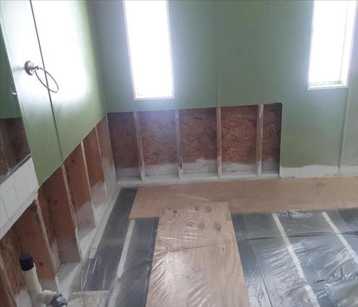 room missing drywall with plastic on the floor