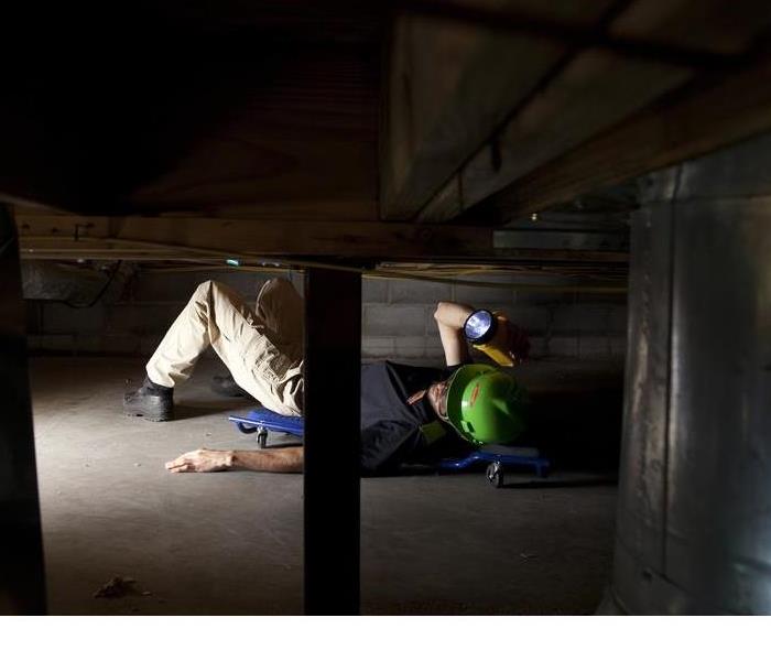 SERVPRO Technician Inspecting the crawl space of a home